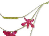 The cords of the necklace are lain out.
